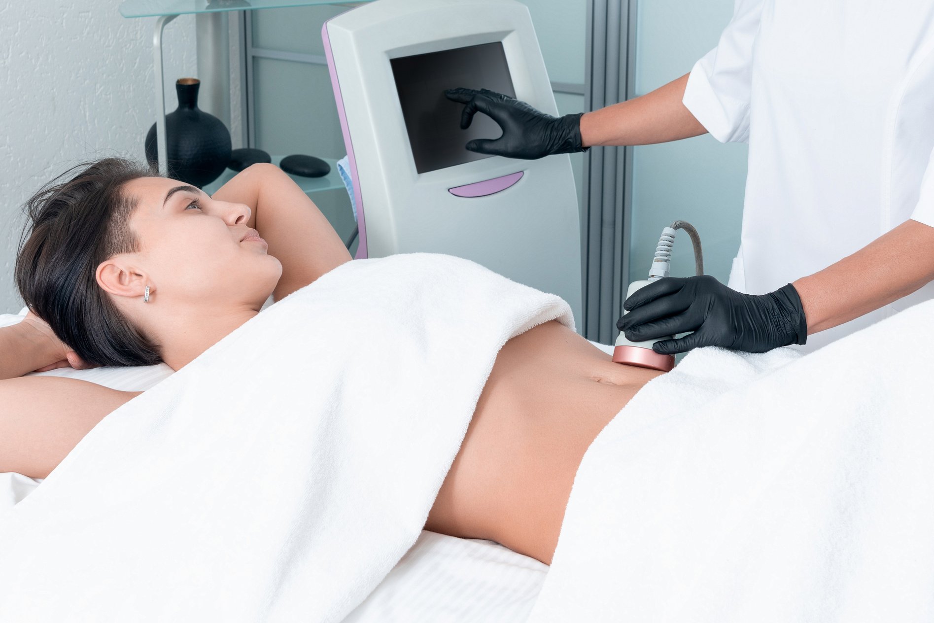 Ultrasound Cavitation Body Contouring Treatment. Woman Getting anti-Cellulite and anti-Fat  on Her Leg in Beauty Salon